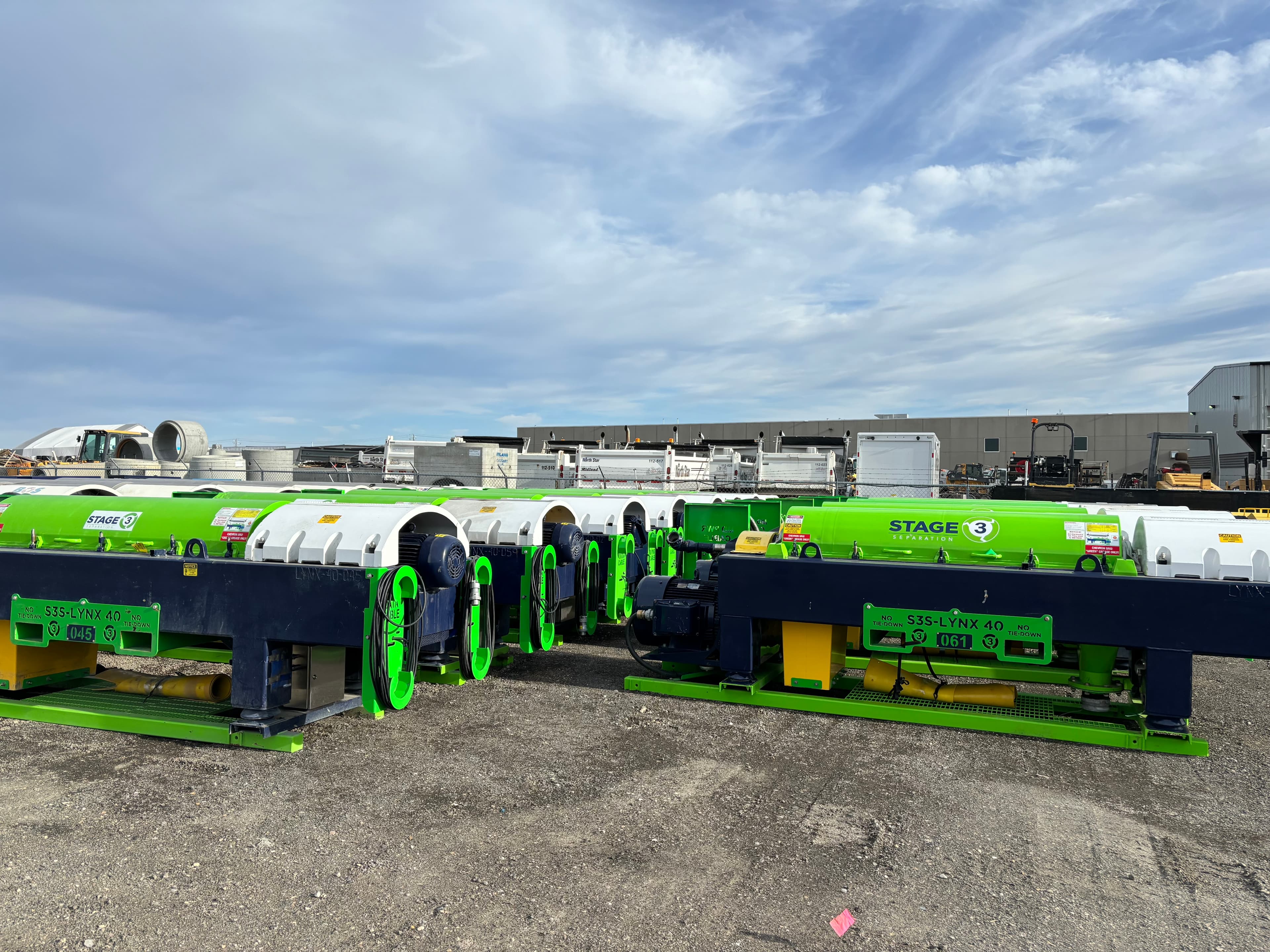 Multiple Stage 3 Separation centrifuges lined up in the equipment yard