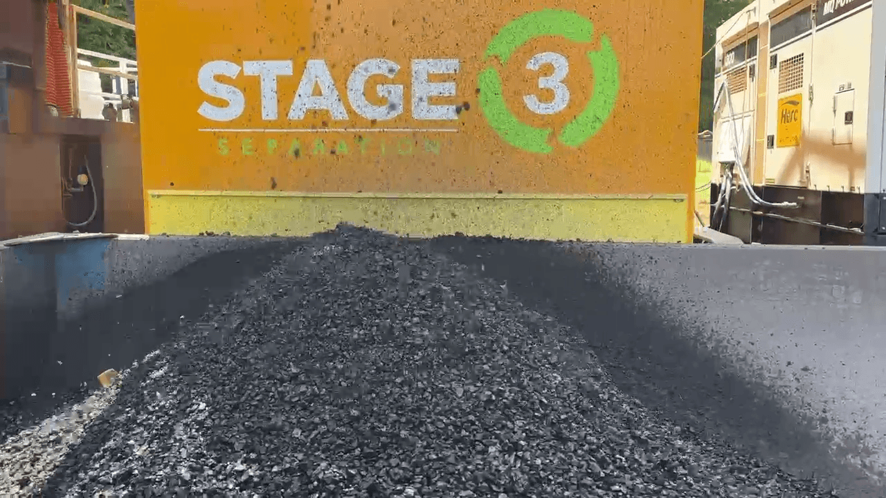 Separated dredging solids discharged from onsite processing equipment