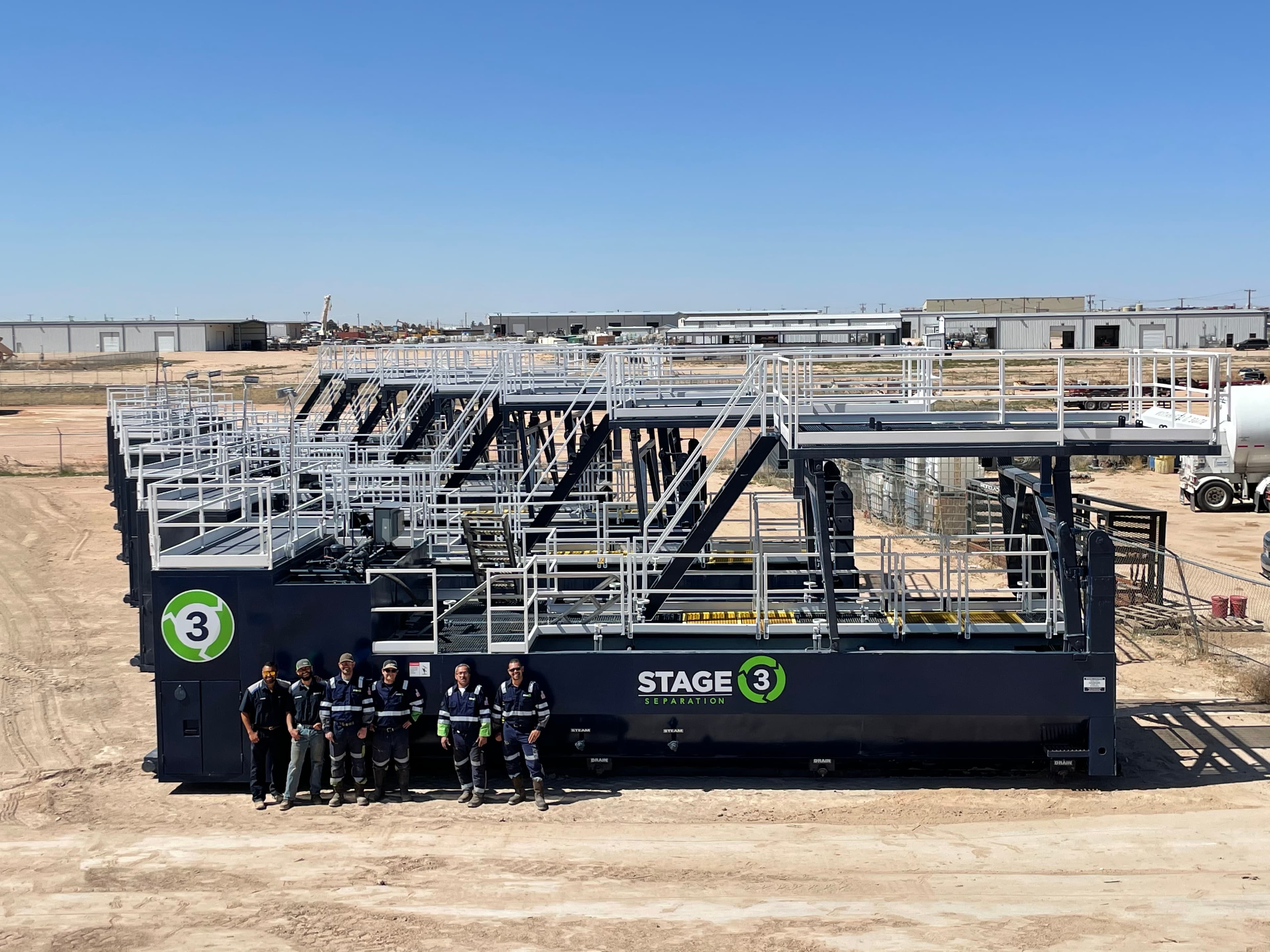 Stage 3 Separation technicians standing with a BOS tank system