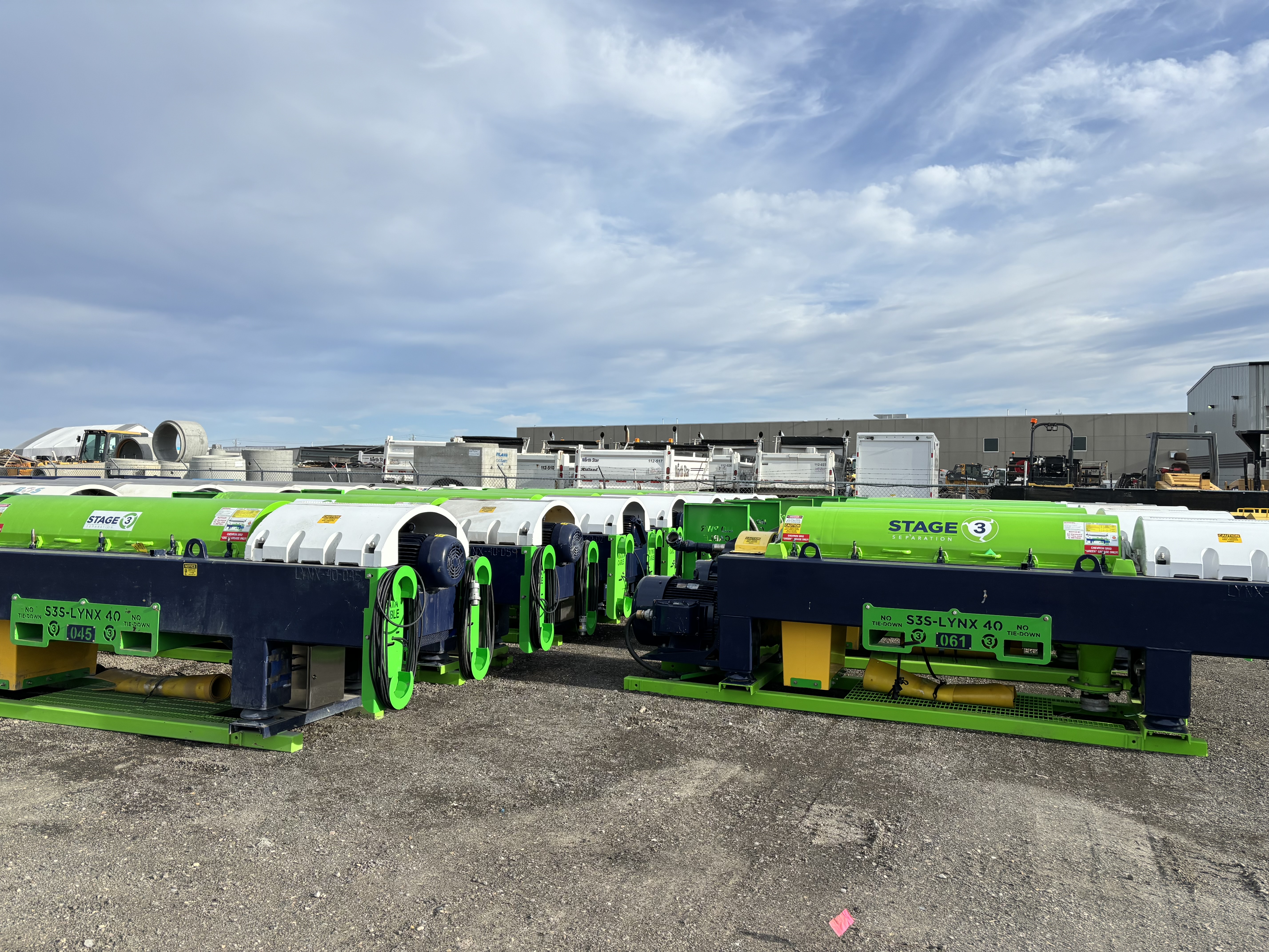Multiple Stage 3 Separation centrifuges lined up in the equipment yard