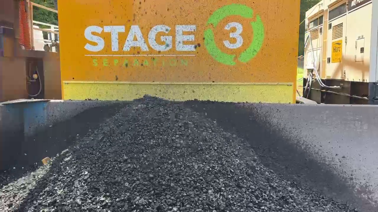 Separated dredging solids discharged from onsite processing equipment