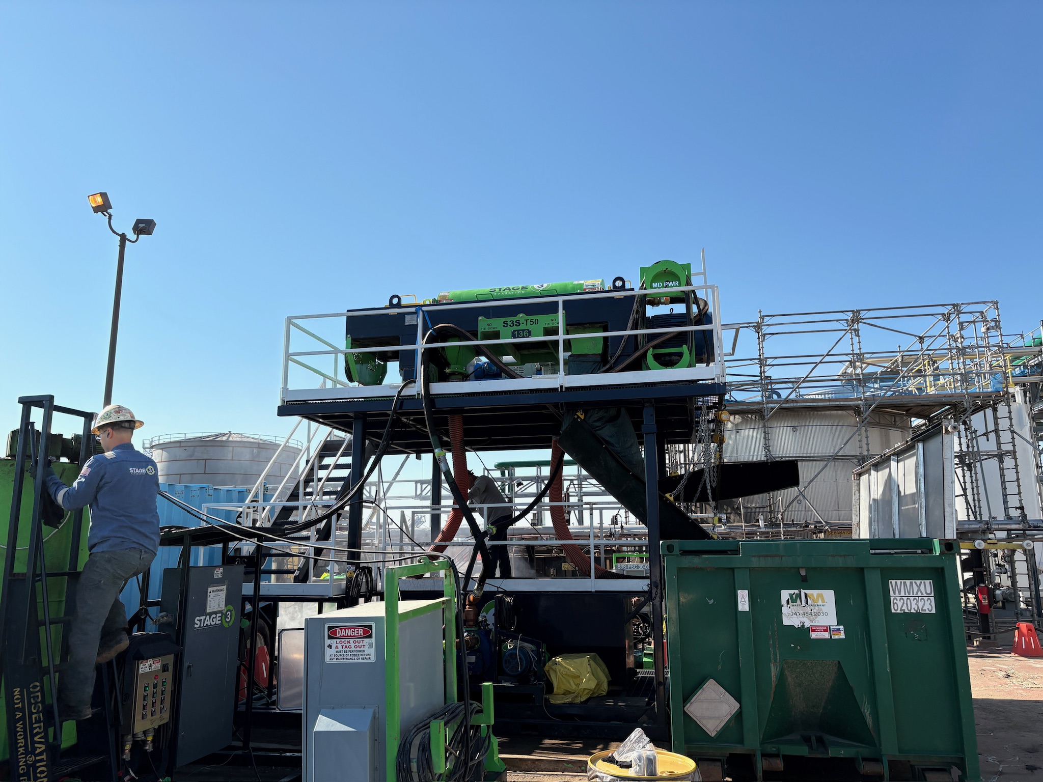 Stage 3 Separation equipment operating beside an industrial refinery pond